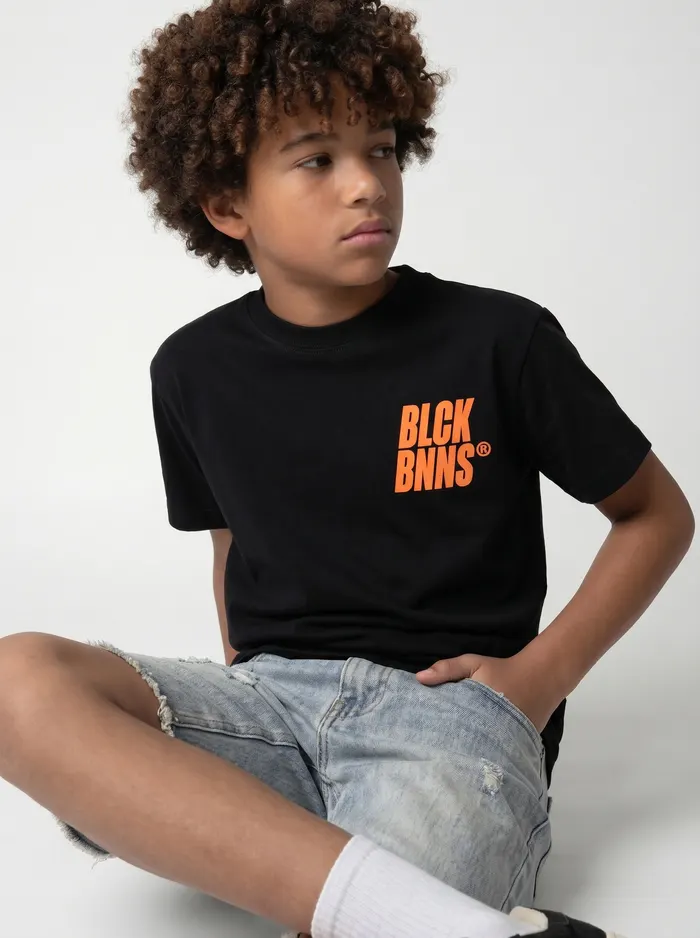 Black Bananas black orange-logo tee alt pose on AI young model in clean studio