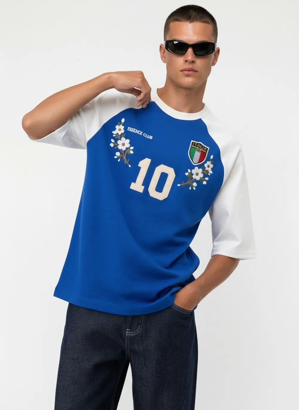 Bully Essence Club raglan tee, hand-to-hip editorial pose, on an AI male model in black sunglasses