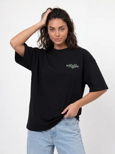 AI-generated half-body front pose — model in black branded oversized tee