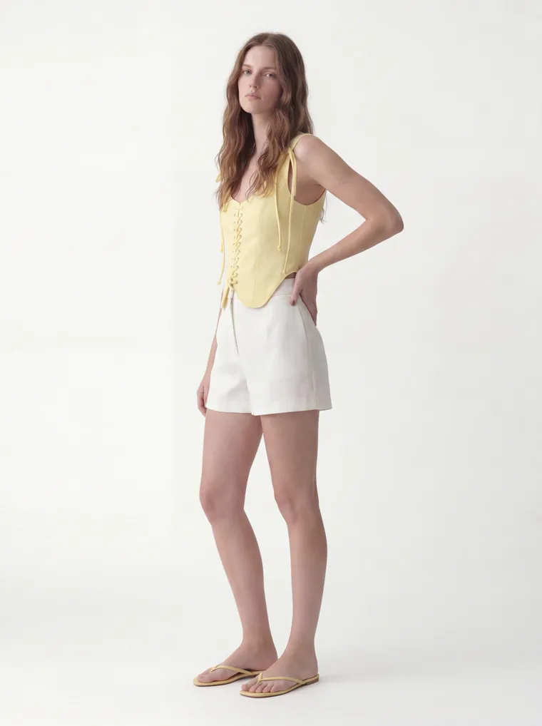 MODA AI catalog output — the vest top in butter yellow, three-quarter angle