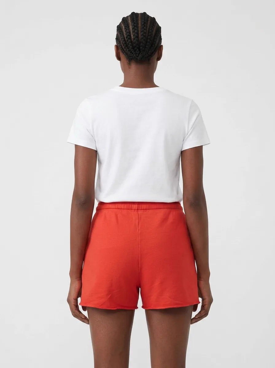 MODA AI catalog output — Black model in white tee and red sweat shorts, full back view showing the silhouette and fit of the shorts on a clean white backdrop
