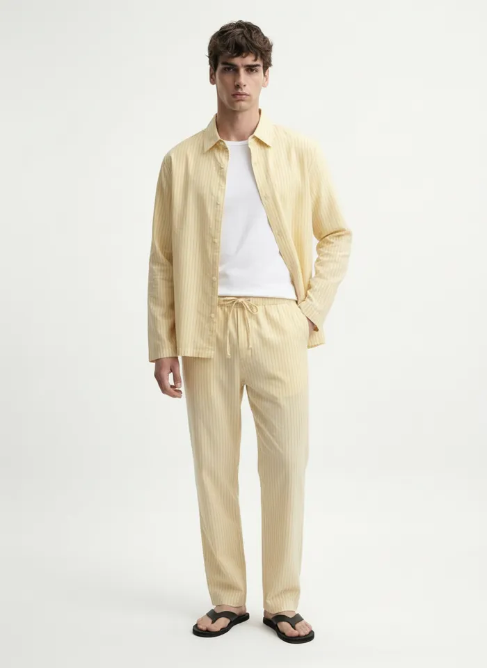 MODA AI on-model output — the pale-yellow overshirt and trousers on a male model, front