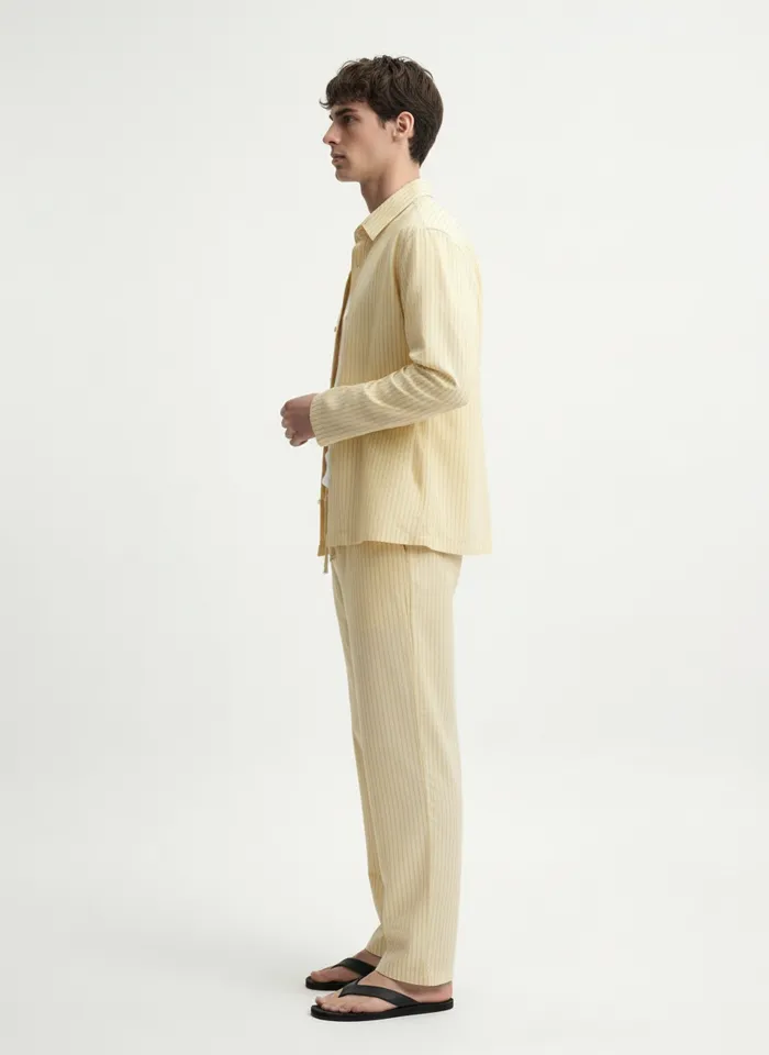 MODA AI on-model output — the yellow overshirt set, side profile