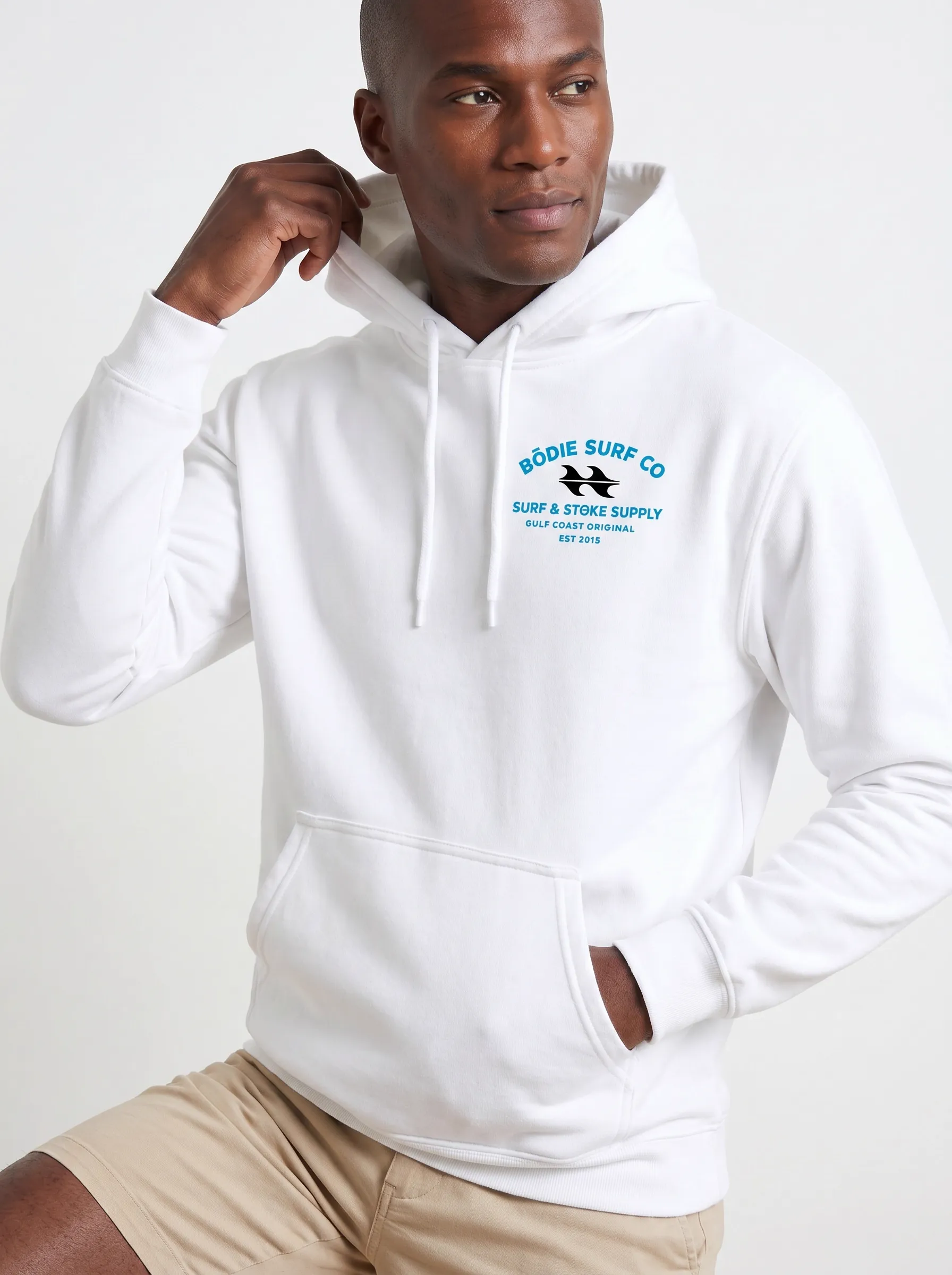MODA AI output 7 — Black male model in white Bödie Surf Co hoodie, chest logo legible, demonstrating logo reproduction and skin tone realism