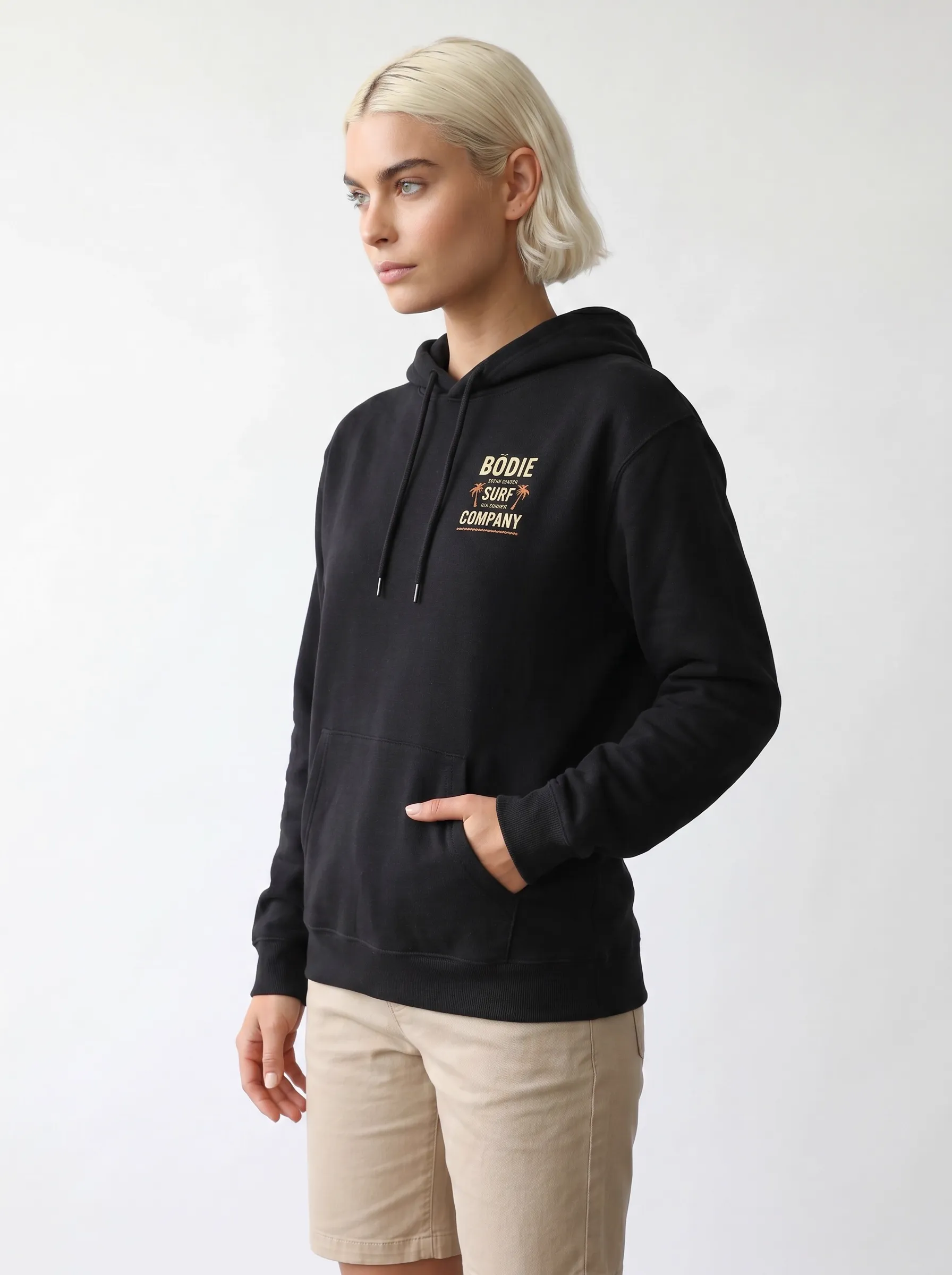 MODA AI back view — black hoodie with bold BÖDIE SURF COMPANY block text logo and palm tree elements