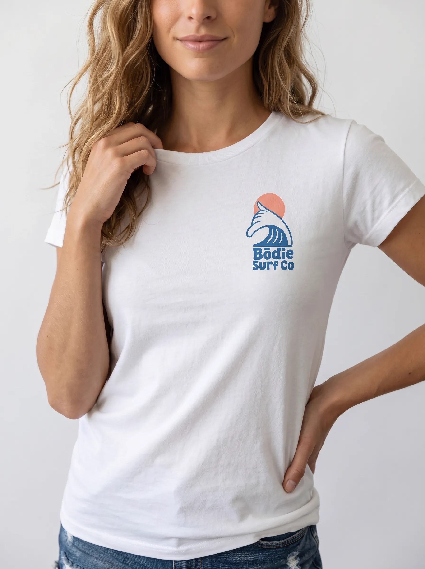 MODA AI output 10 — brunette female model in white Bödie Surf Co tee, locked by face reference, chest wave logo consistent across catalog angle