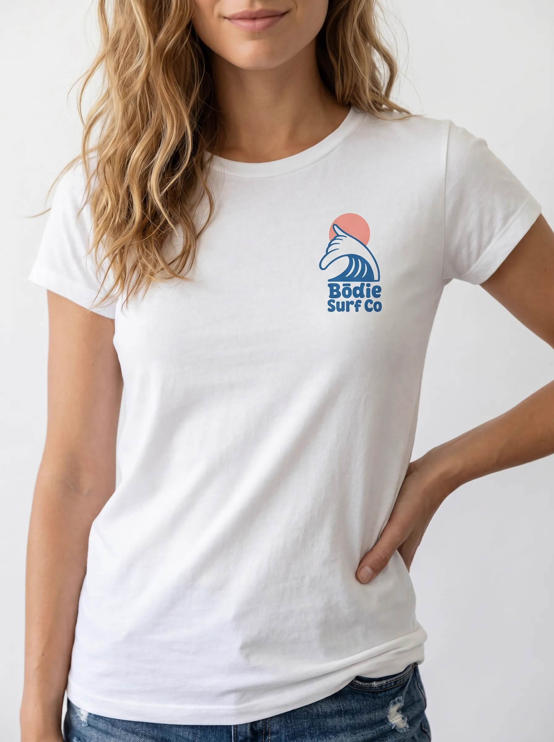 MODA AI output 7 — brunette female model in white Bödie Surf Co tee, locked by face reference, chest wave logo consistent across catalog angle