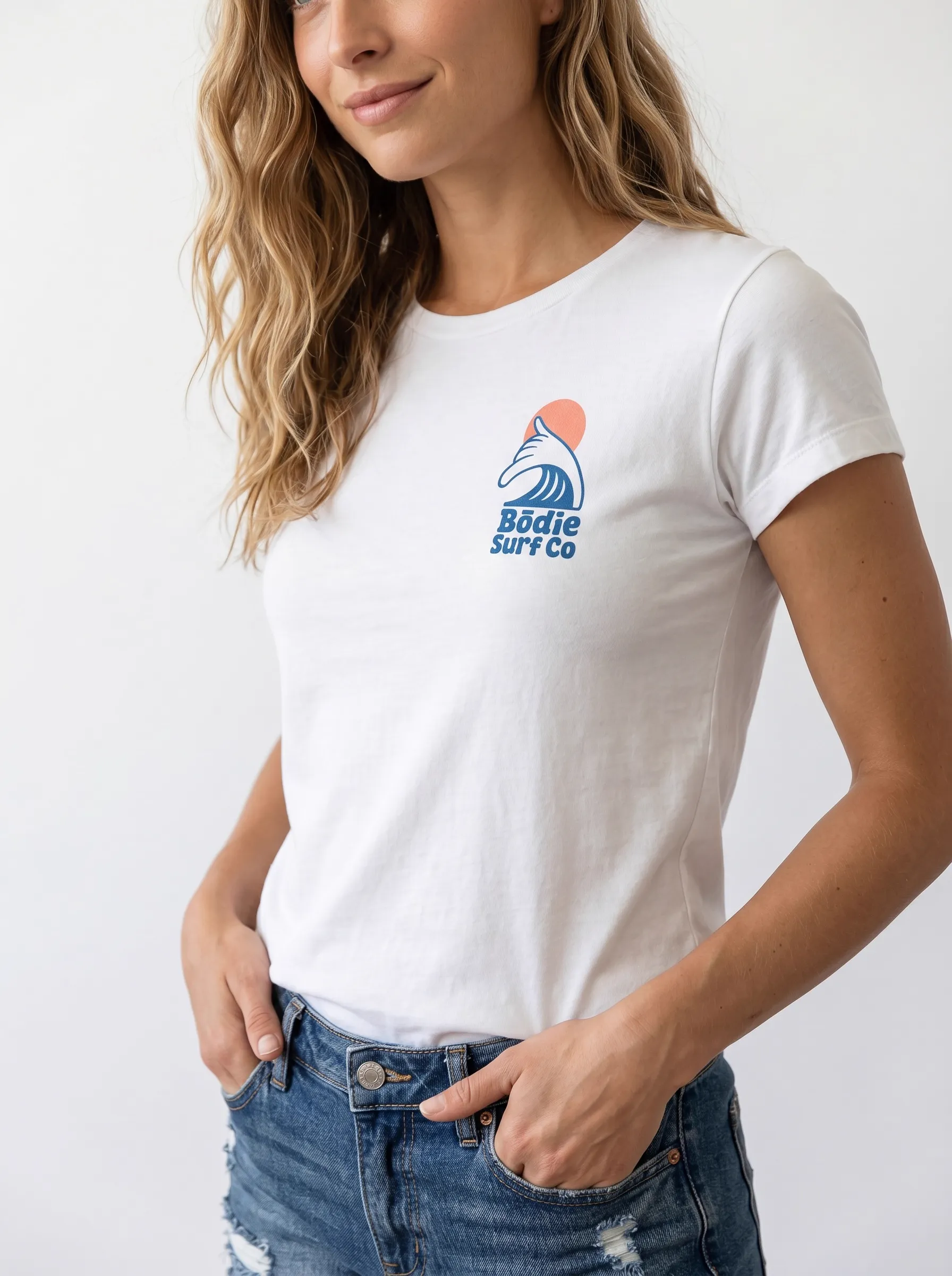MODA AI output 9 — brunette female model in white Bödie Surf Co tee, locked by face reference, chest wave logo consistent across catalog angle