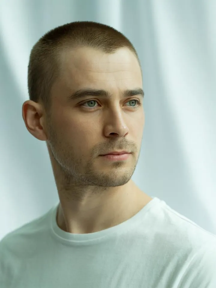 Face reference — buzz-cut male model with light eyes