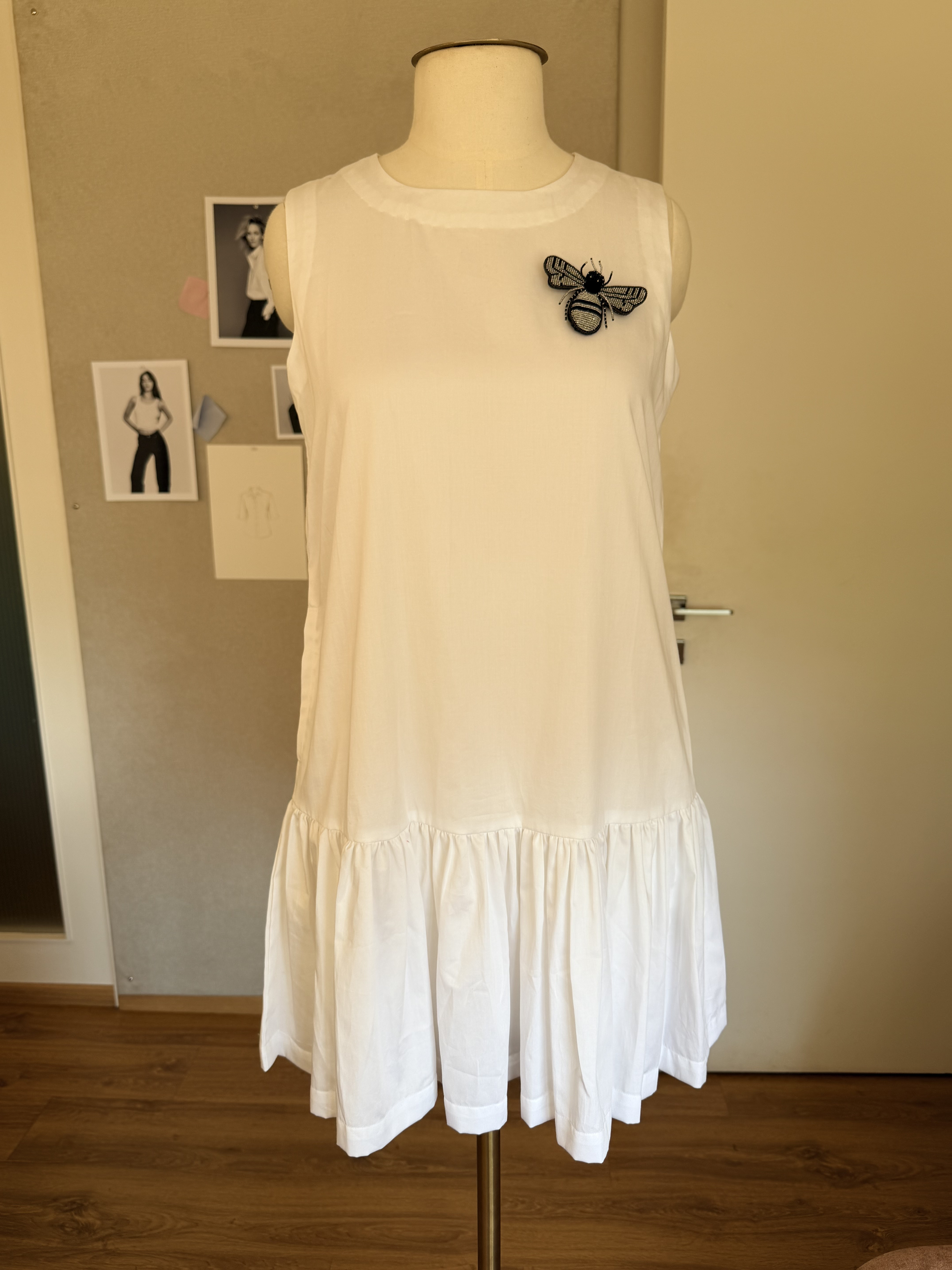 White dress on mannequin — front view in studio
