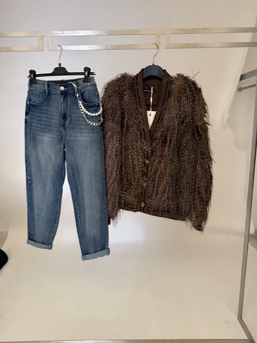 The starting photo for the shaggy faux-fur jacket: the faux-fur jacket and jeans on hangers on a rail