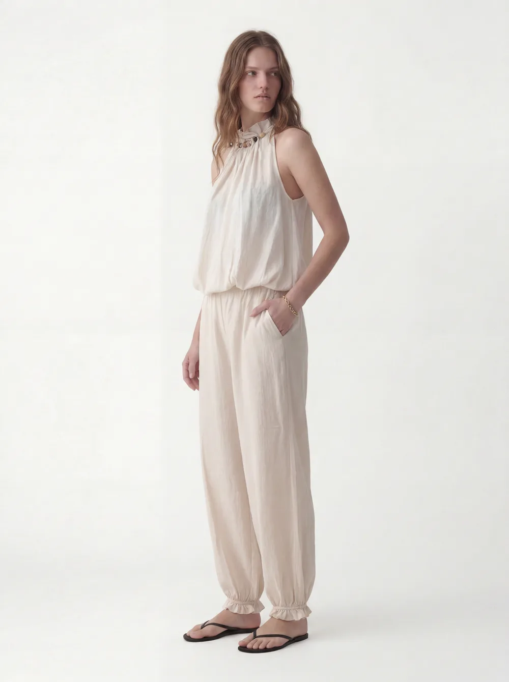 MODA catalog shot 2 of 10 — the generated model in the cream halter jumpsuit, consistent across every angle