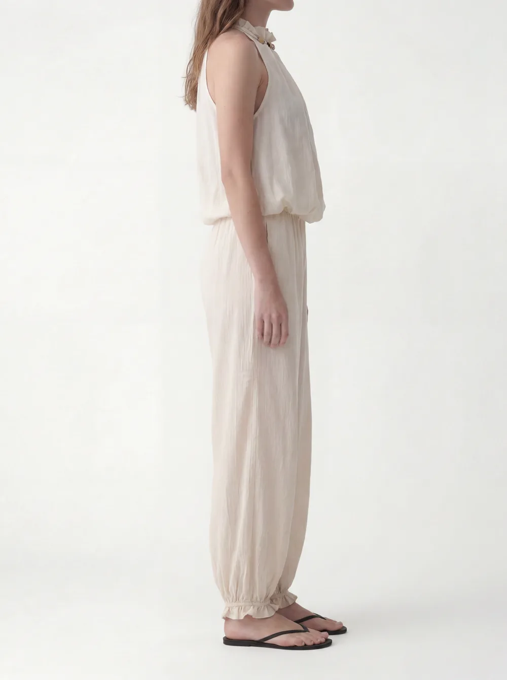 MODA catalog shot 4 of 10 — the generated model in the cream halter jumpsuit, consistent across every angle