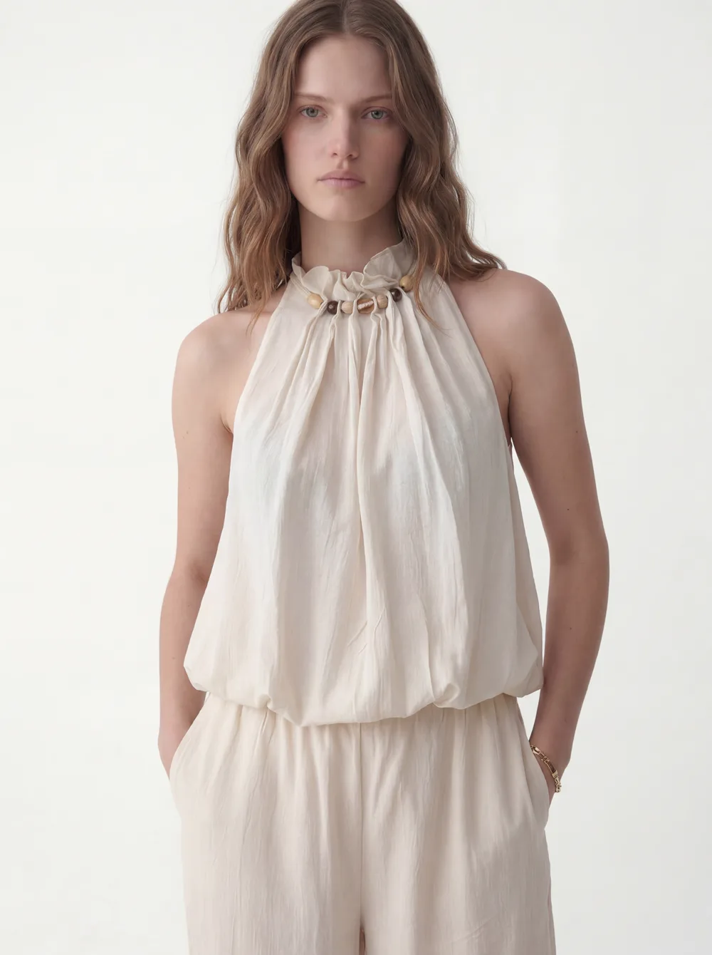 MODA catalog shot 7 of 10 — the generated model in the cream halter jumpsuit, consistent across every angle