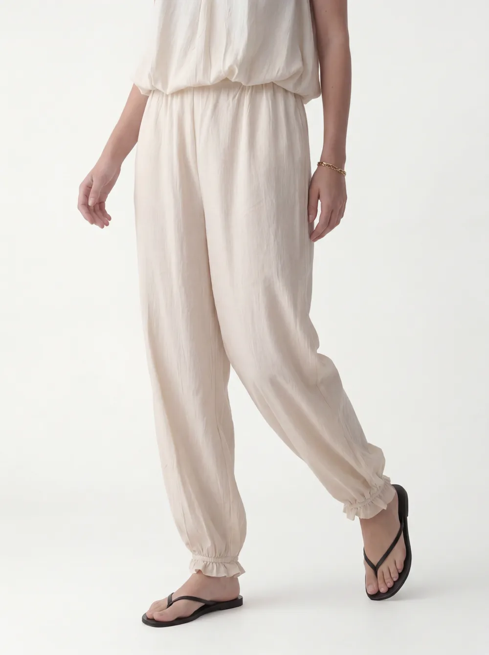 MODA catalog shot 9 of 10 — the generated model in the cream halter jumpsuit, consistent across every angle